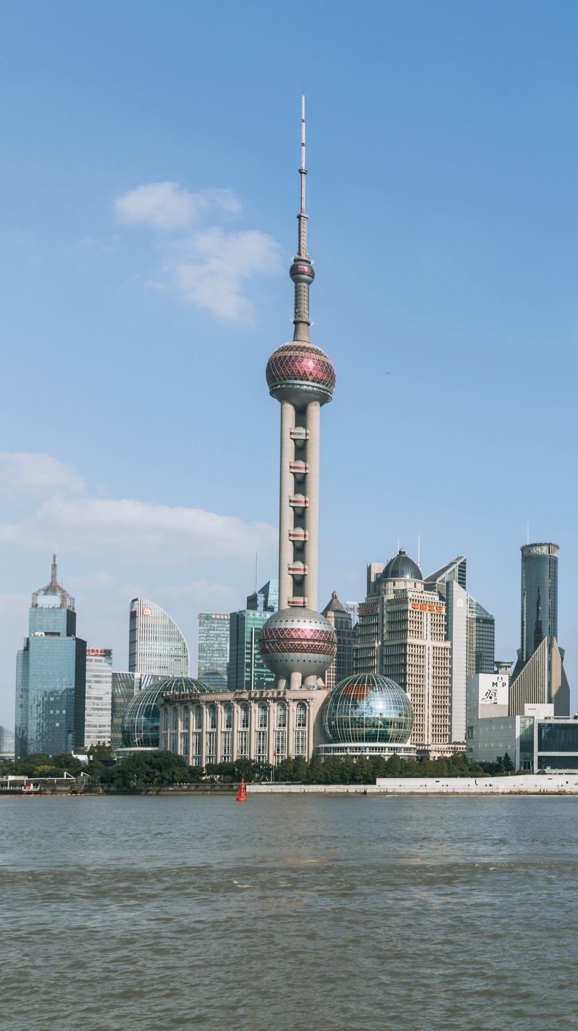 Exploring Pudong's skyline with iconic architecture near The Bund in Shanghai, China during a sunny day