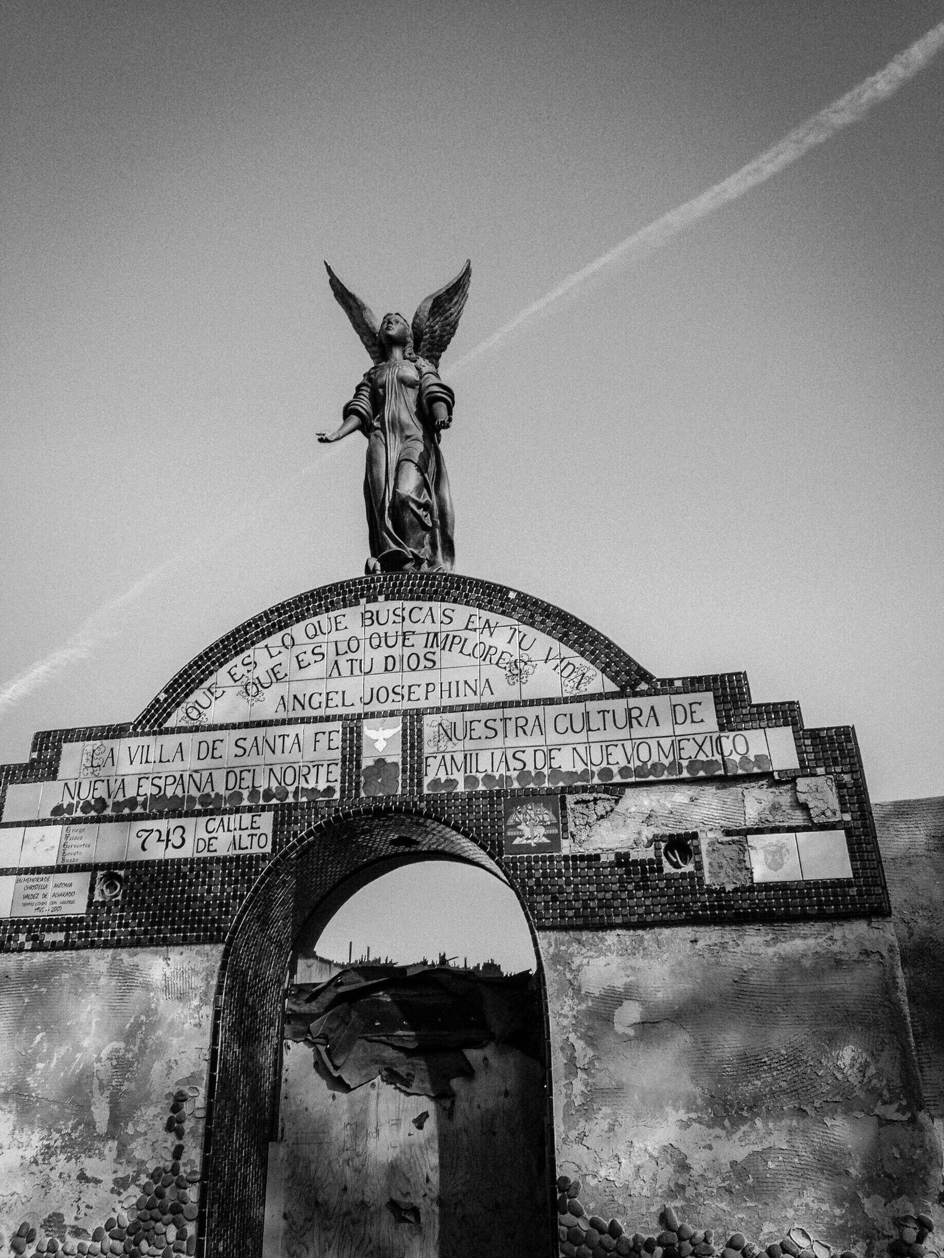 This is a purely residential area with nothing to offer but great people and amazing Old Santa Fe architecture.  It's one of those "only locals know" streets.  

#CeliaLuzPhotography #BW #architecture #SantaFe #NewMexico #statue #streetart #local #travel #angel 