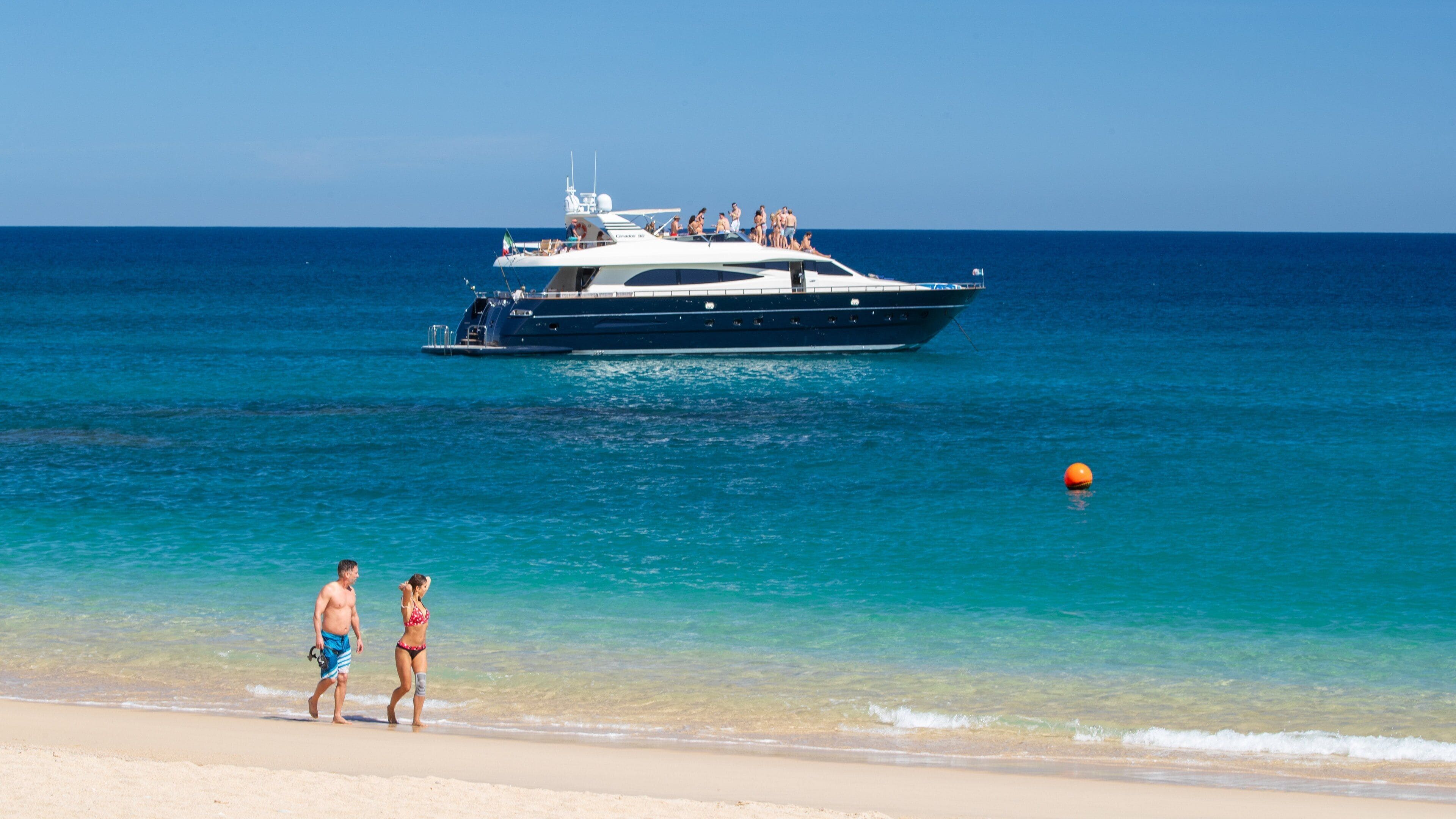 Chileno Beach which includes general coastal views, boating and a sandy beach