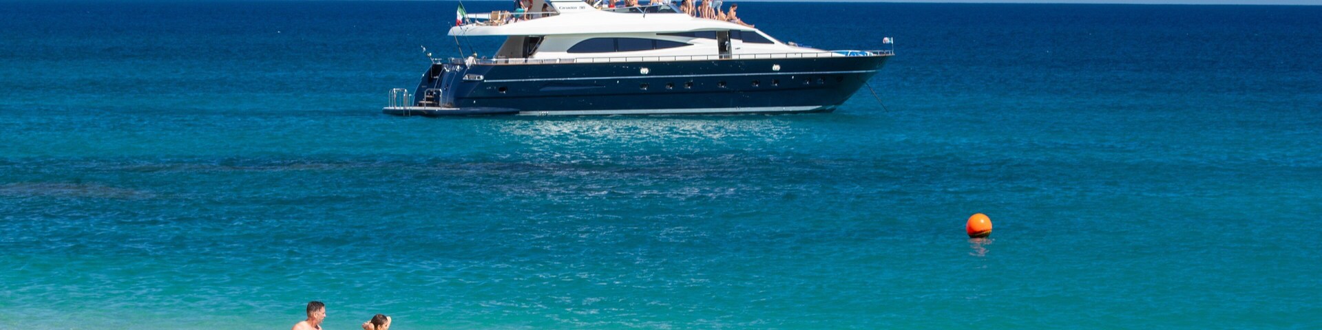 Chileno Beach which includes general coastal views, boating and a sandy beach