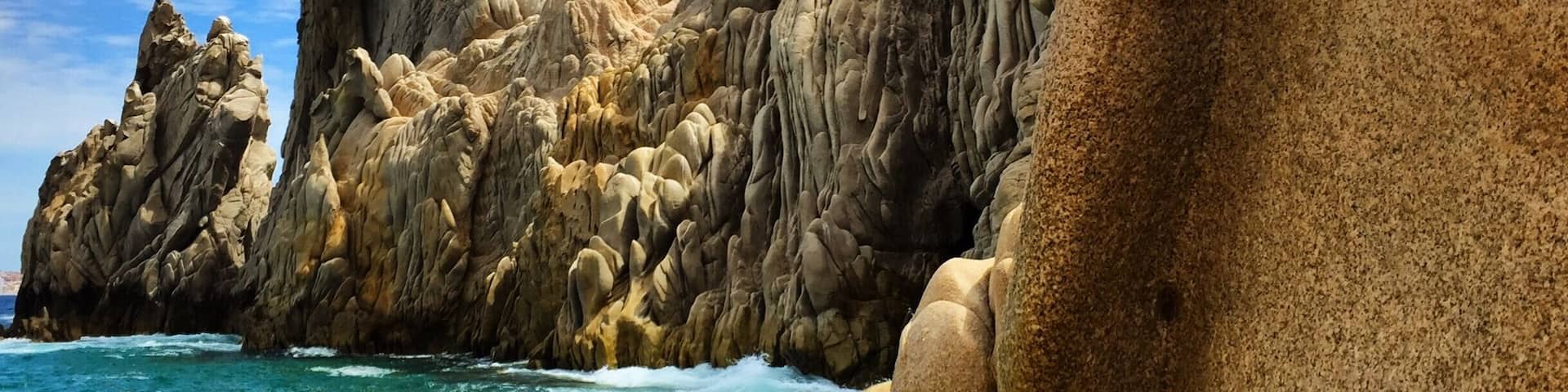 Lovers Beach. It's a sandy area between the cliffs that you take a boat ride to get to