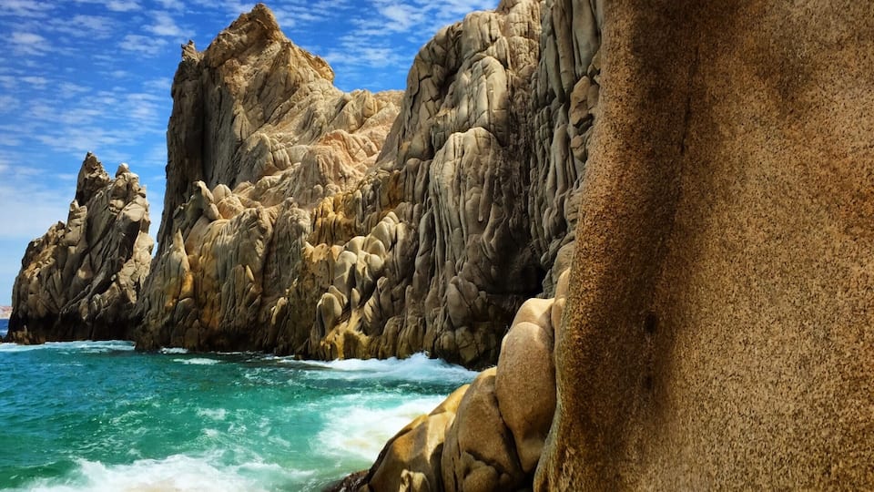 Lovers Beach. It's a sandy area between the cliffs that you take a boat ride to get to