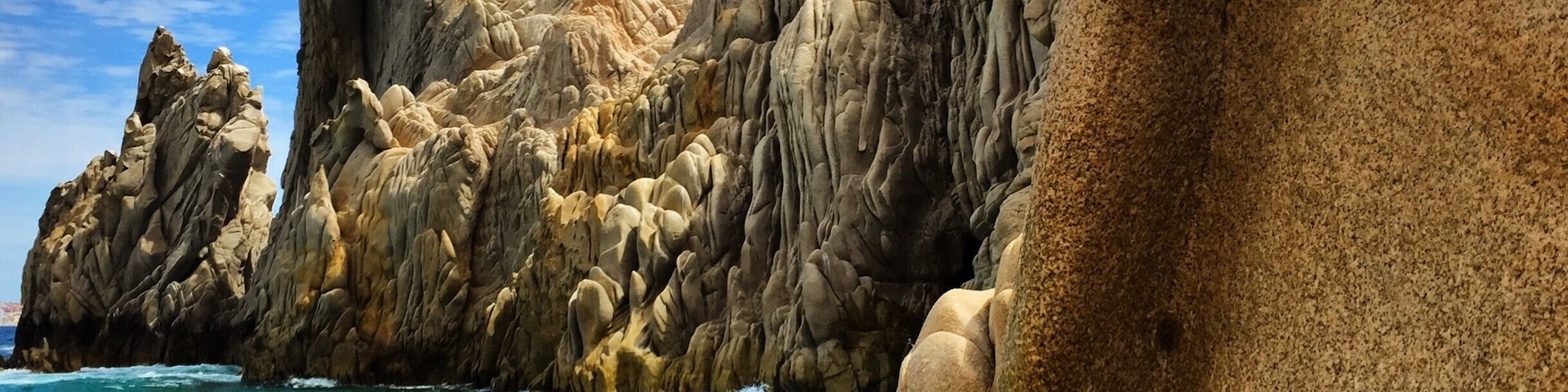 Lovers Beach. It's a sandy area between the cliffs that you take a boat ride to get to