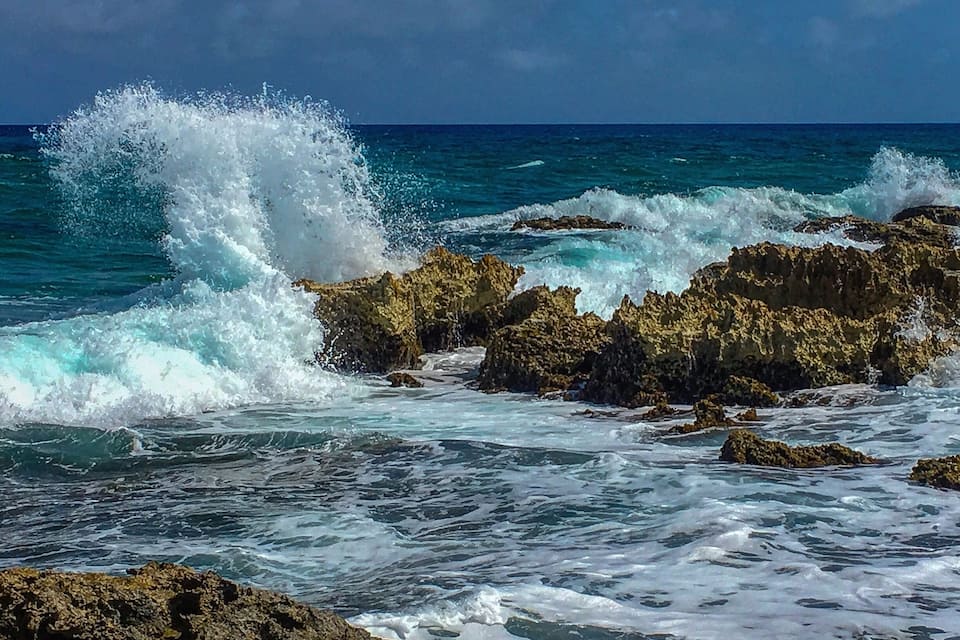 A rocky coastline with waves crashing against the rocks.