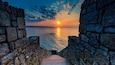 A stone pathway leading to a sunset over water, with the text 'FORTY STEPS' visible on the path.