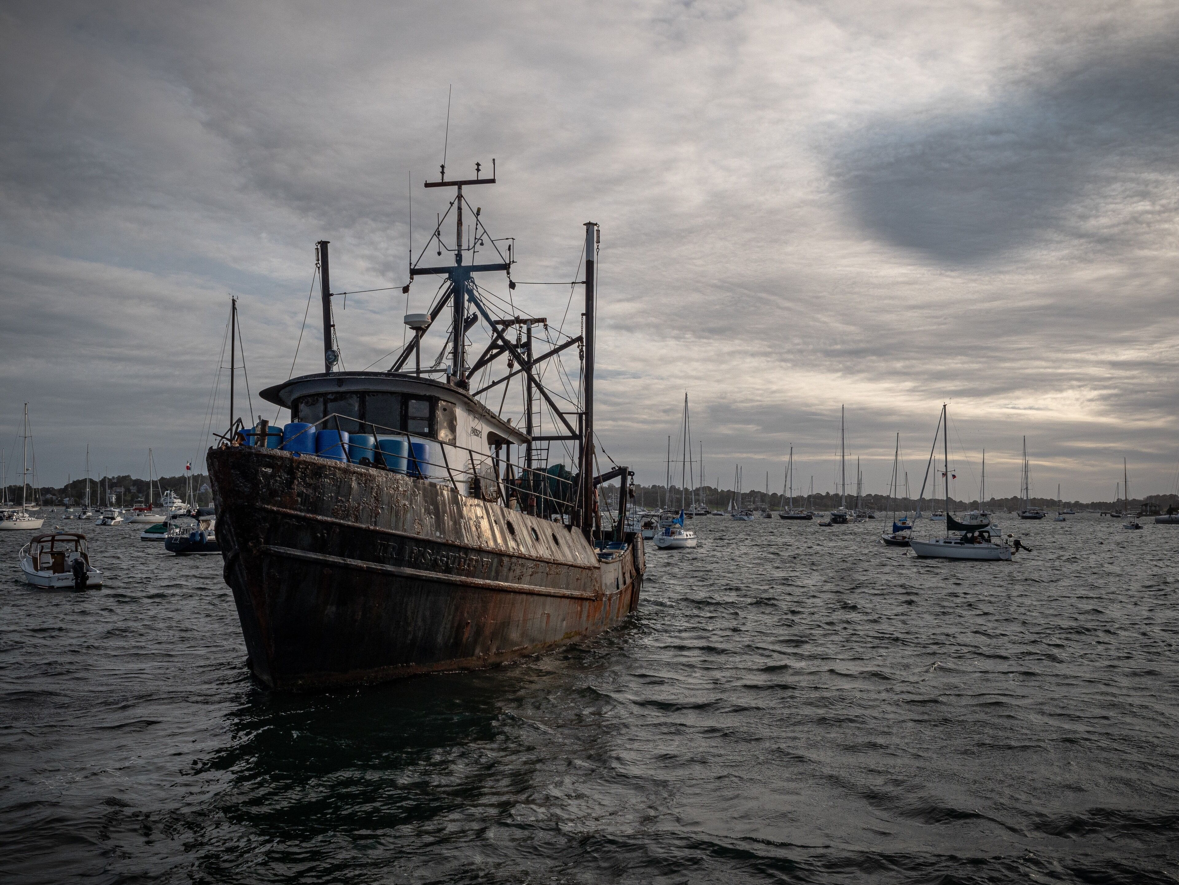 An old shrimp boat leaves the dock at dusk for a night of shrimping in the Atlantic. #rhodeisland