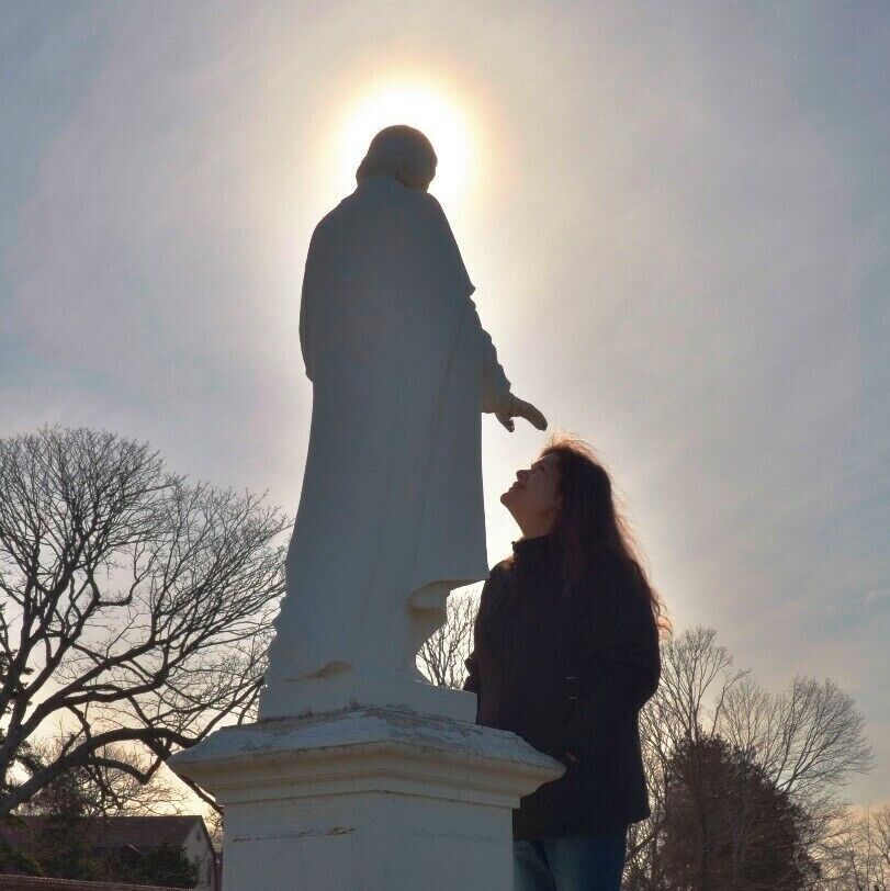 Touched by an angel. 

Late in the day on a cold, exhausting, afternoon, I saw this miraculous sight of a woman looking for spiritual inspiration. Something tells me, she found it. 