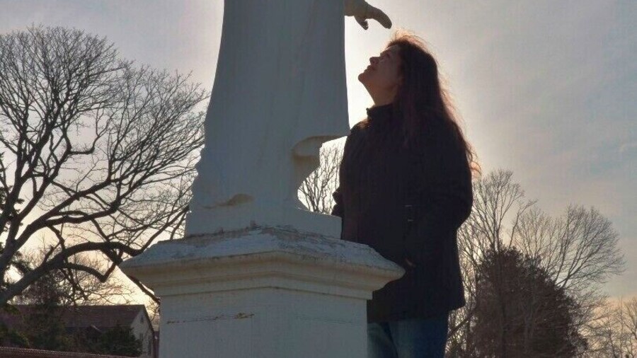 Touched by an angel.
Late in the day on a cold, exhausting, afternoon, I saw this miraculous sight of a woman looking for spiritual inspiration. Something tells me, she found it.