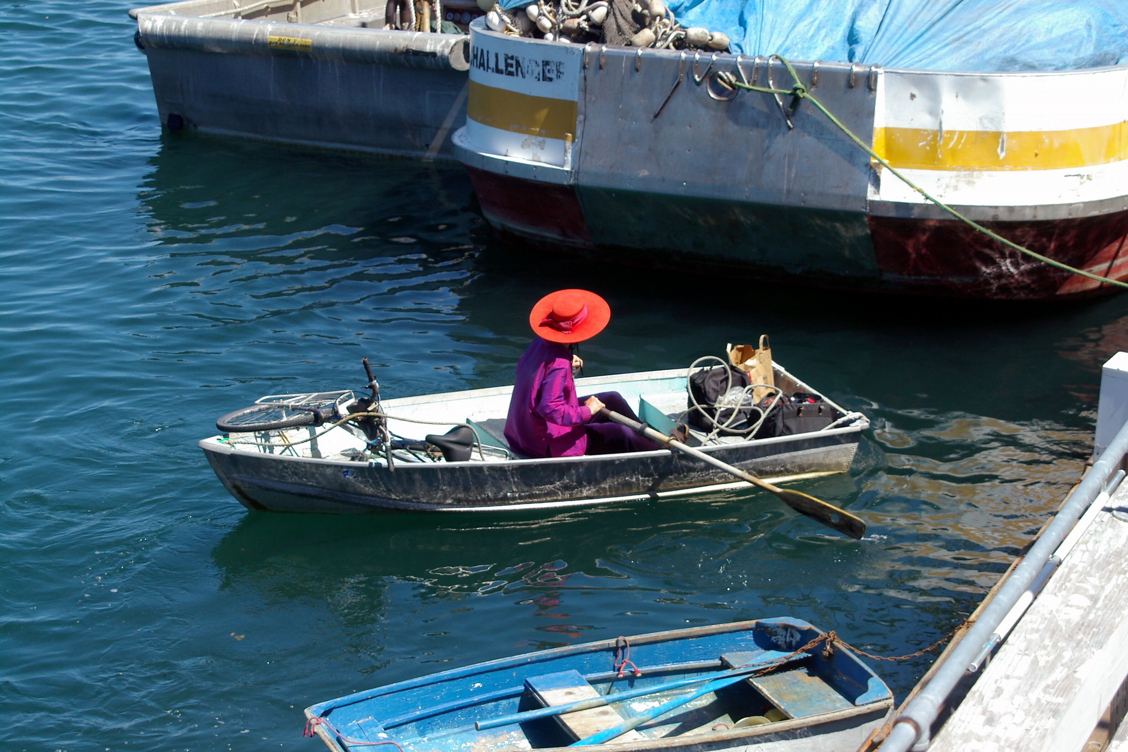 This lady was living aboard a houseboat anchored in the harbor. She would dress for dining or shopping, put her bicycle in the boat and row ashore.