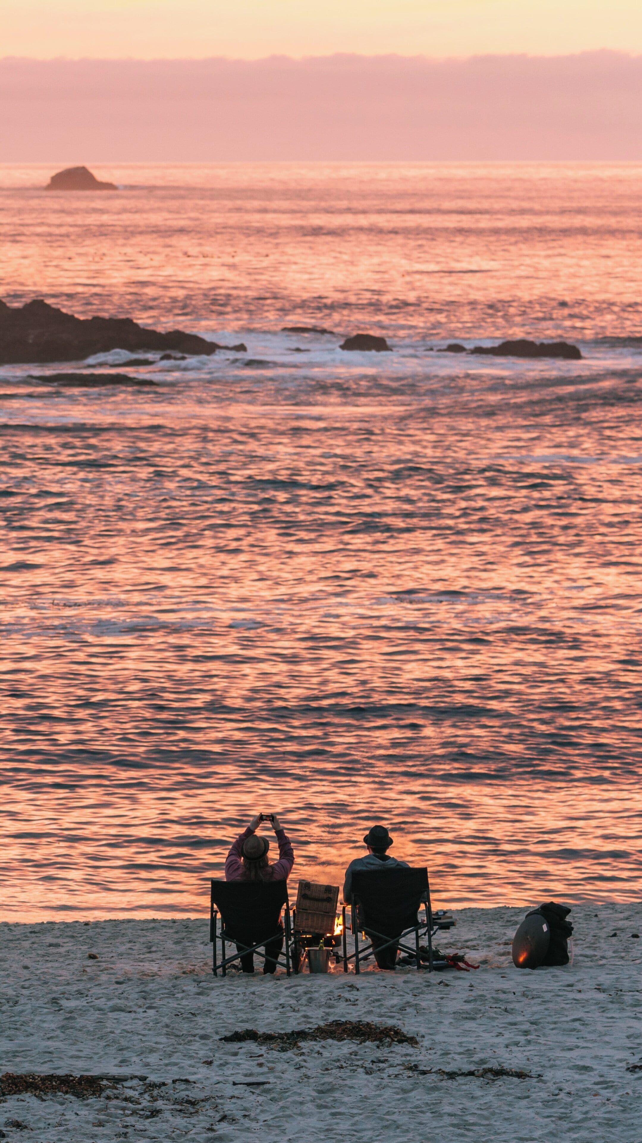 Sunset at 17-Mile Drive in Monterey, California with People Relaxing by the Shore