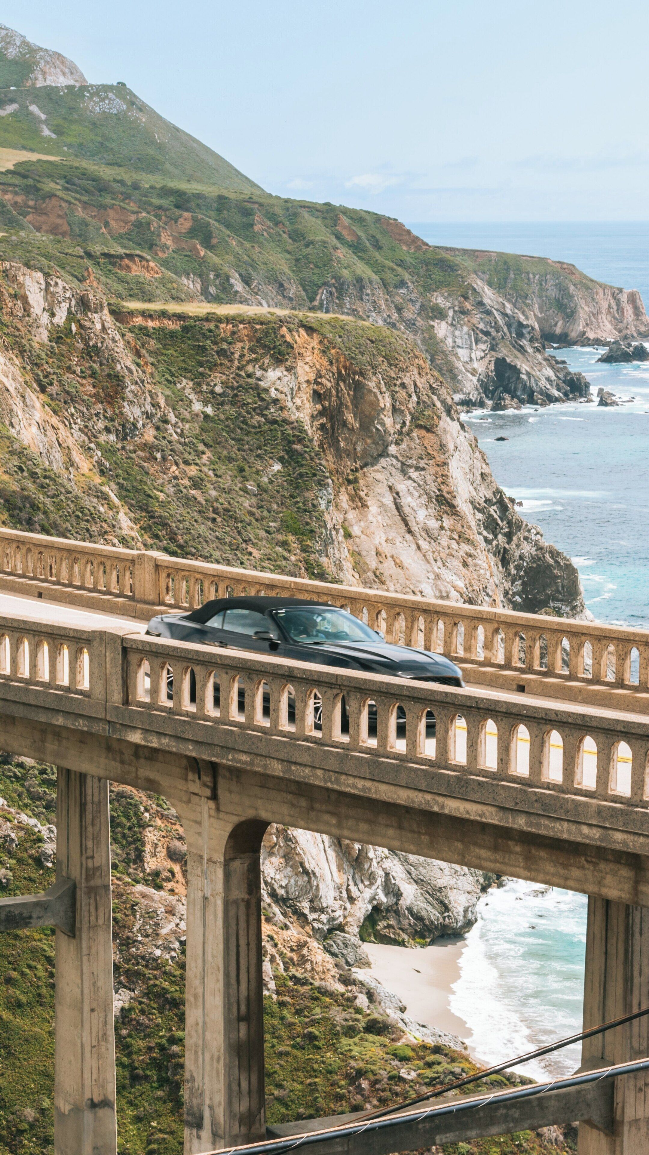 Bixby Bridge spans stunning cliffs above the Pacific Ocean in Carmel, California, showcasing beautiful coastal views and scenic drives