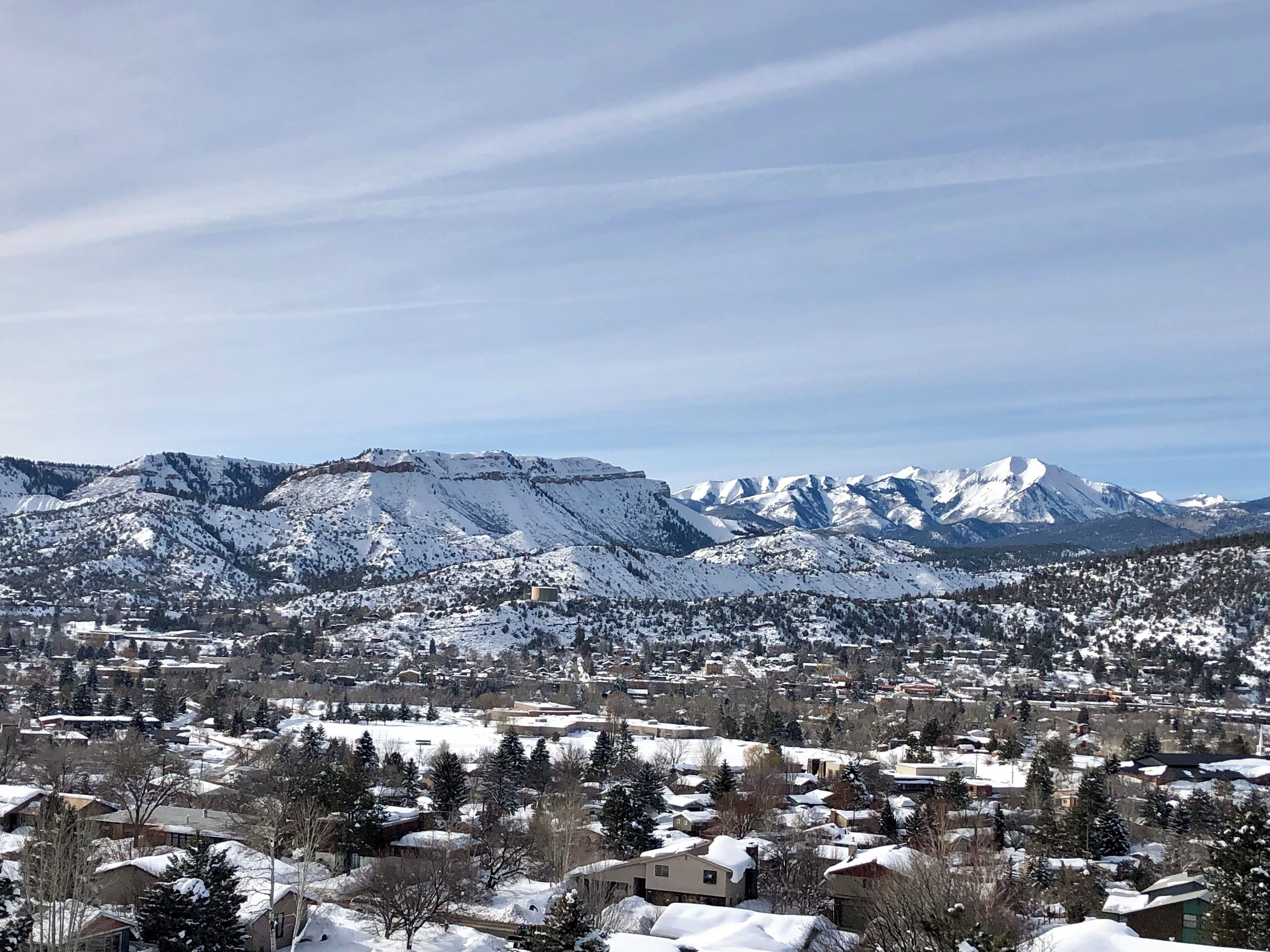A snow-covered town with mountains in the background.