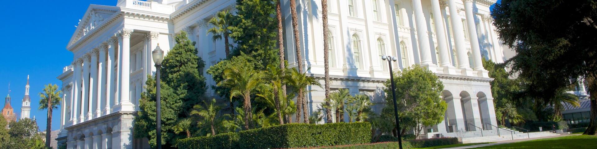 Stunning view of Sacramento's historic state capitol building surrounded by greenery and clear blue skies