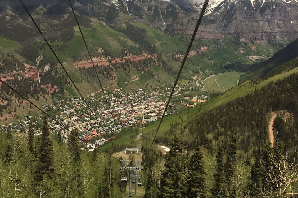 A cable car system with a mountainous landscape in the background.
