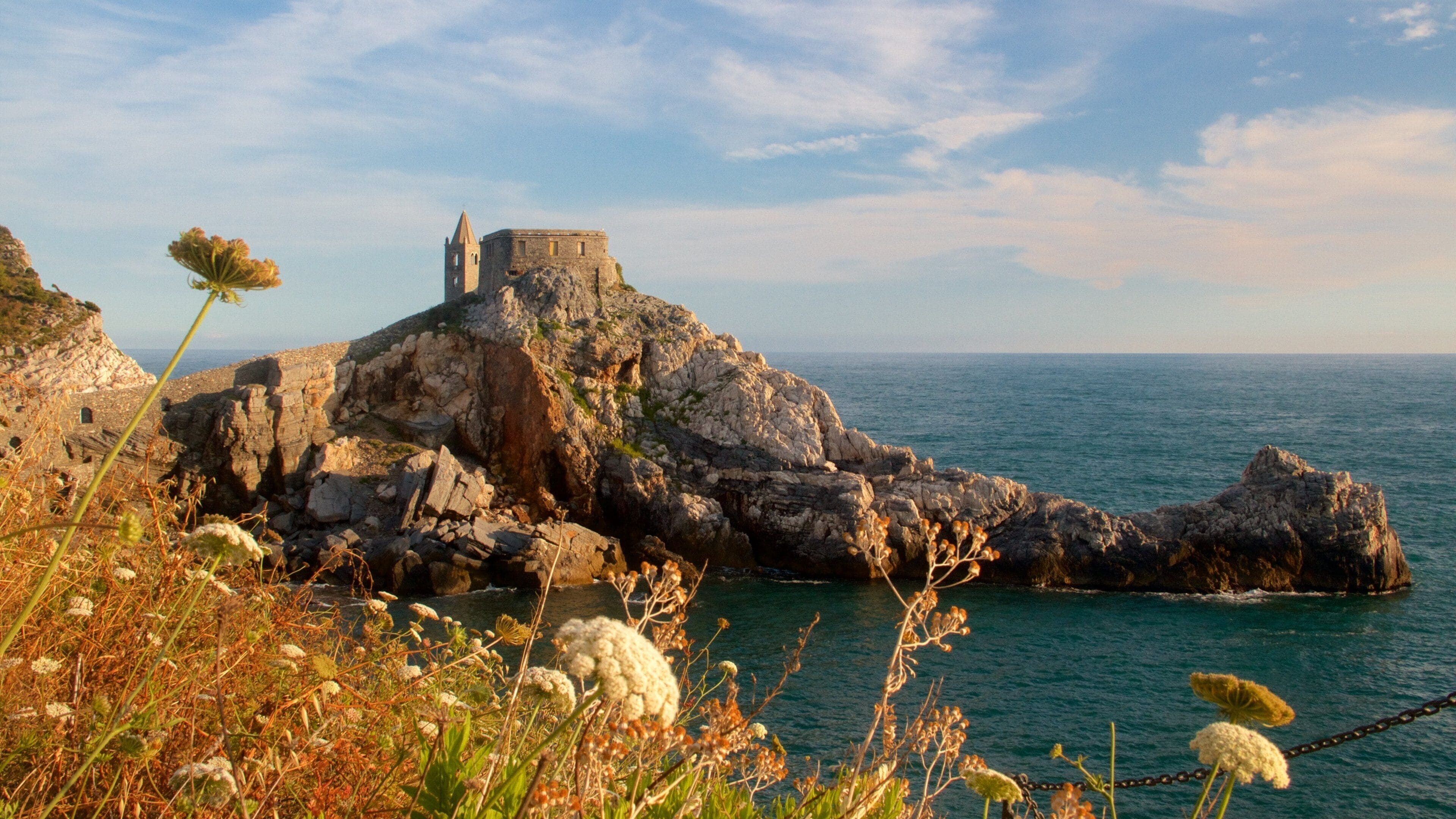 A coastal fortress on a rocky outcrop with the sea in the background.