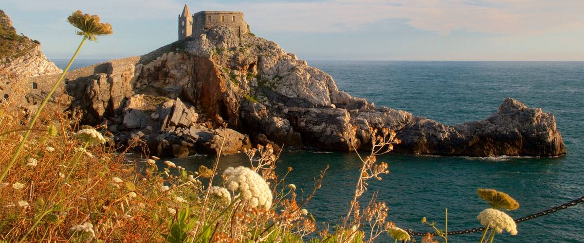 A coastal fortress on a rocky outcrop with the sea in the background.