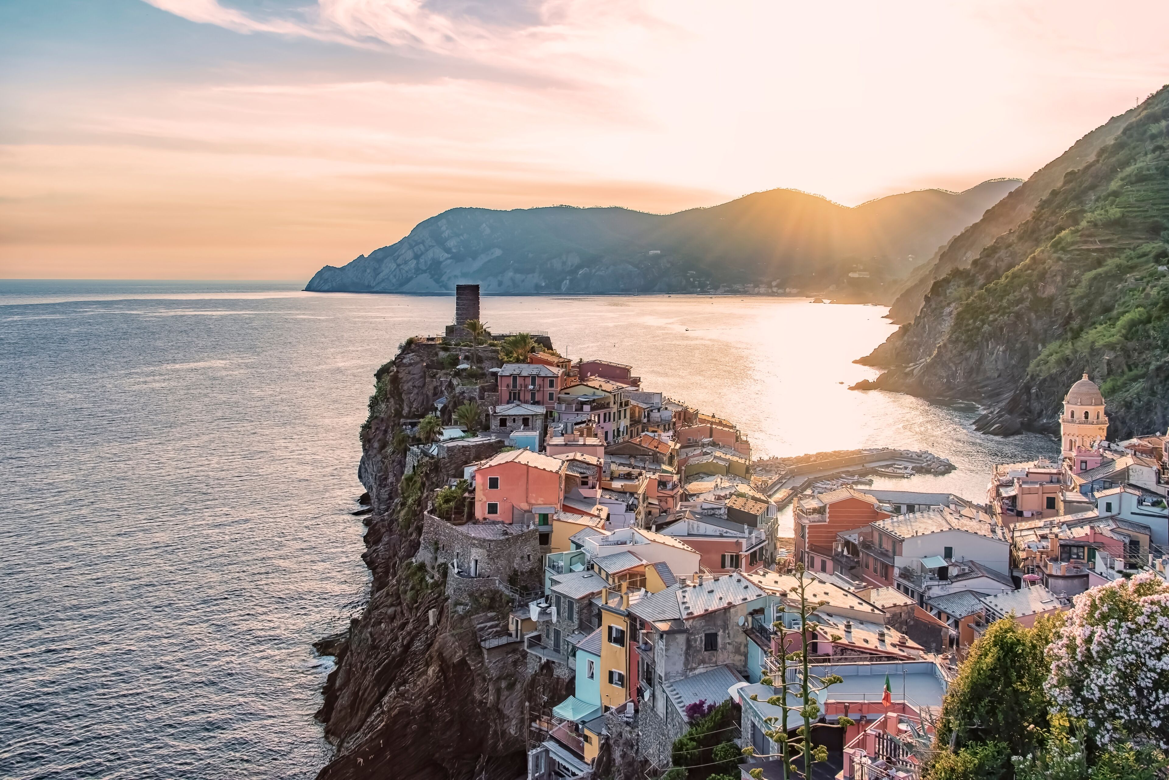 A coastal village with colorful buildings perched on a cliff overlooking the sea.