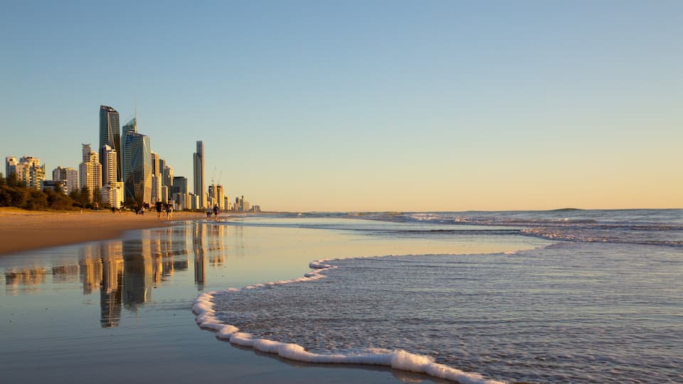 A beach with a city skyline in the background.