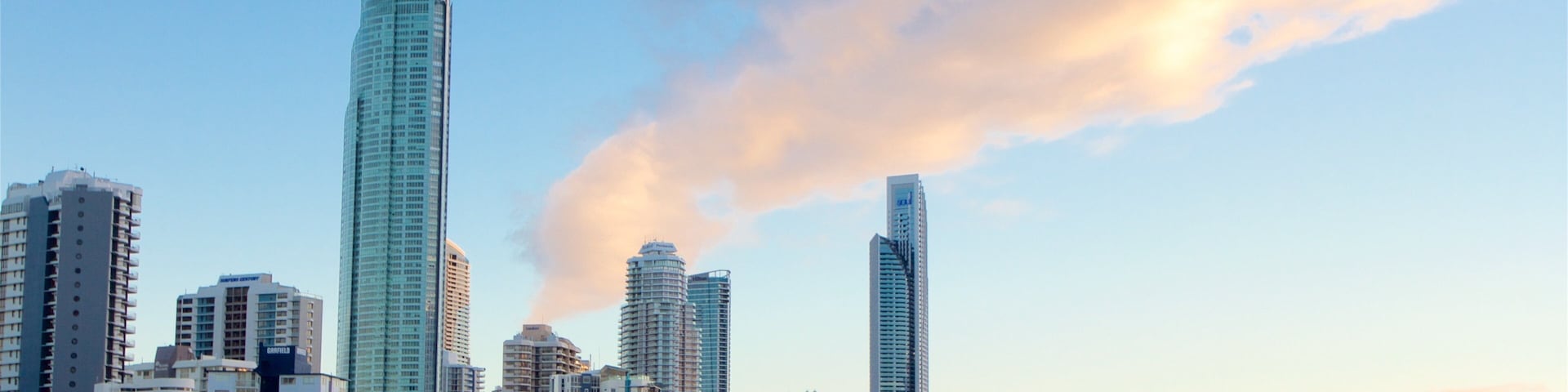 Gold Coast showing a skyscraper, general coastal views and a sunset