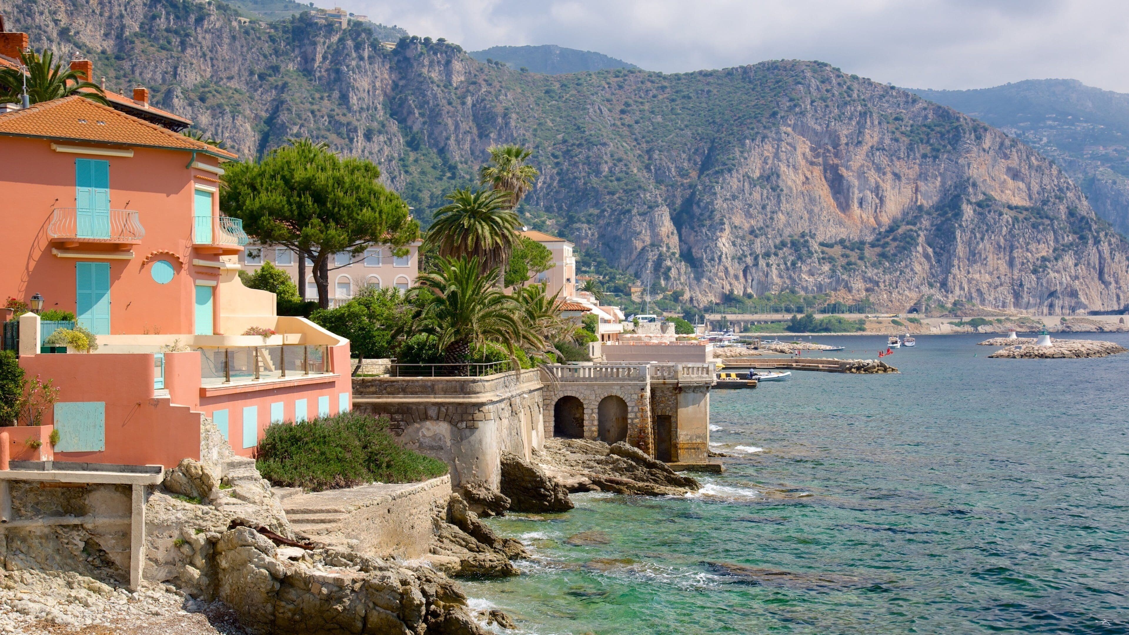 Nice which includes a coastal town and rocky coastline