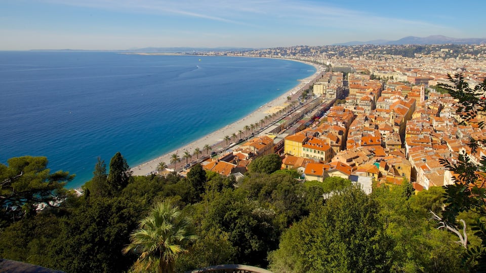 A coastal city with a beach, dense urban area, and surrounding greenery.