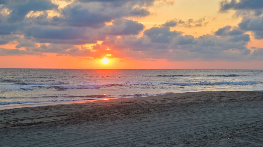 Sunset on a beach in Acapulco, Pie de la Cuesta beach, sun setting to the horizon in Mexico