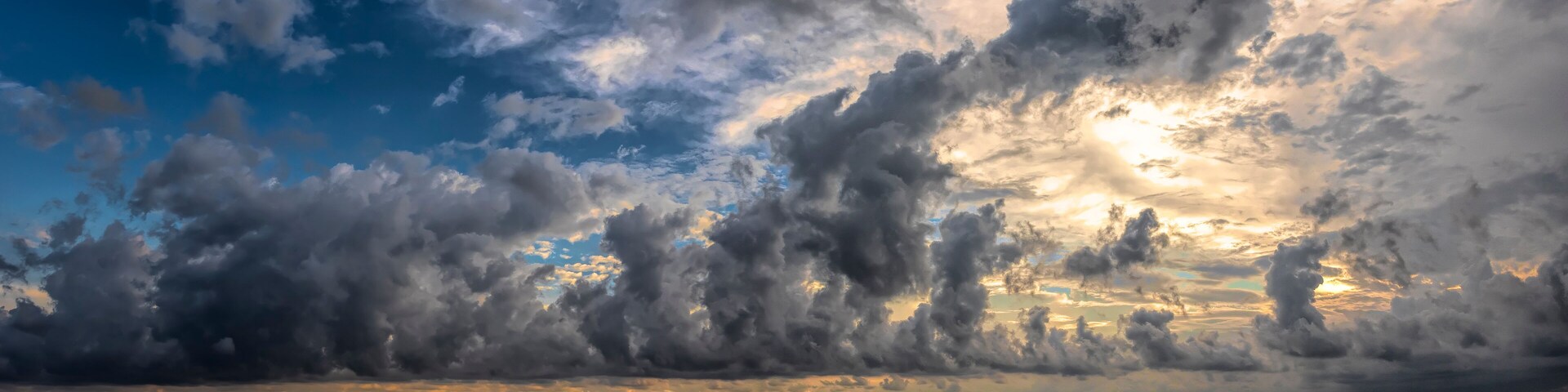 seascape of storm clouds at sunset over the sandy beach at Pie de la Cuesta in Acapulco, Mexico with dramatic light