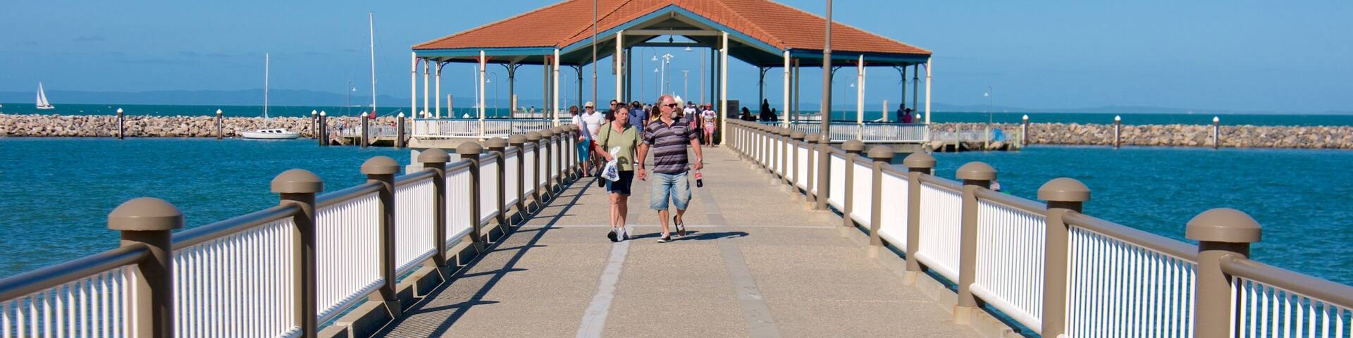 Redcliffe featuring general coastal views as well as a small group of people