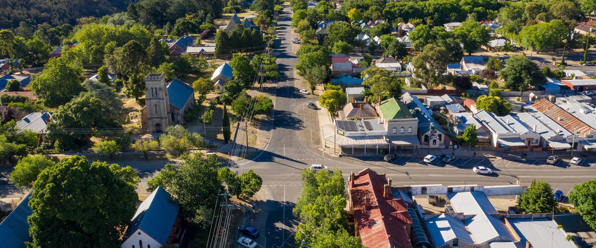 A town with a prominent church, a main street, and surrounding hills.