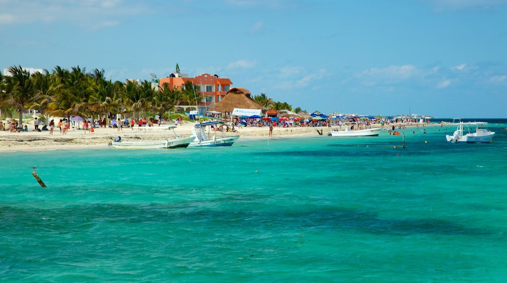 Puerto Morelos which includes a coastal town, tropical scenes and boating