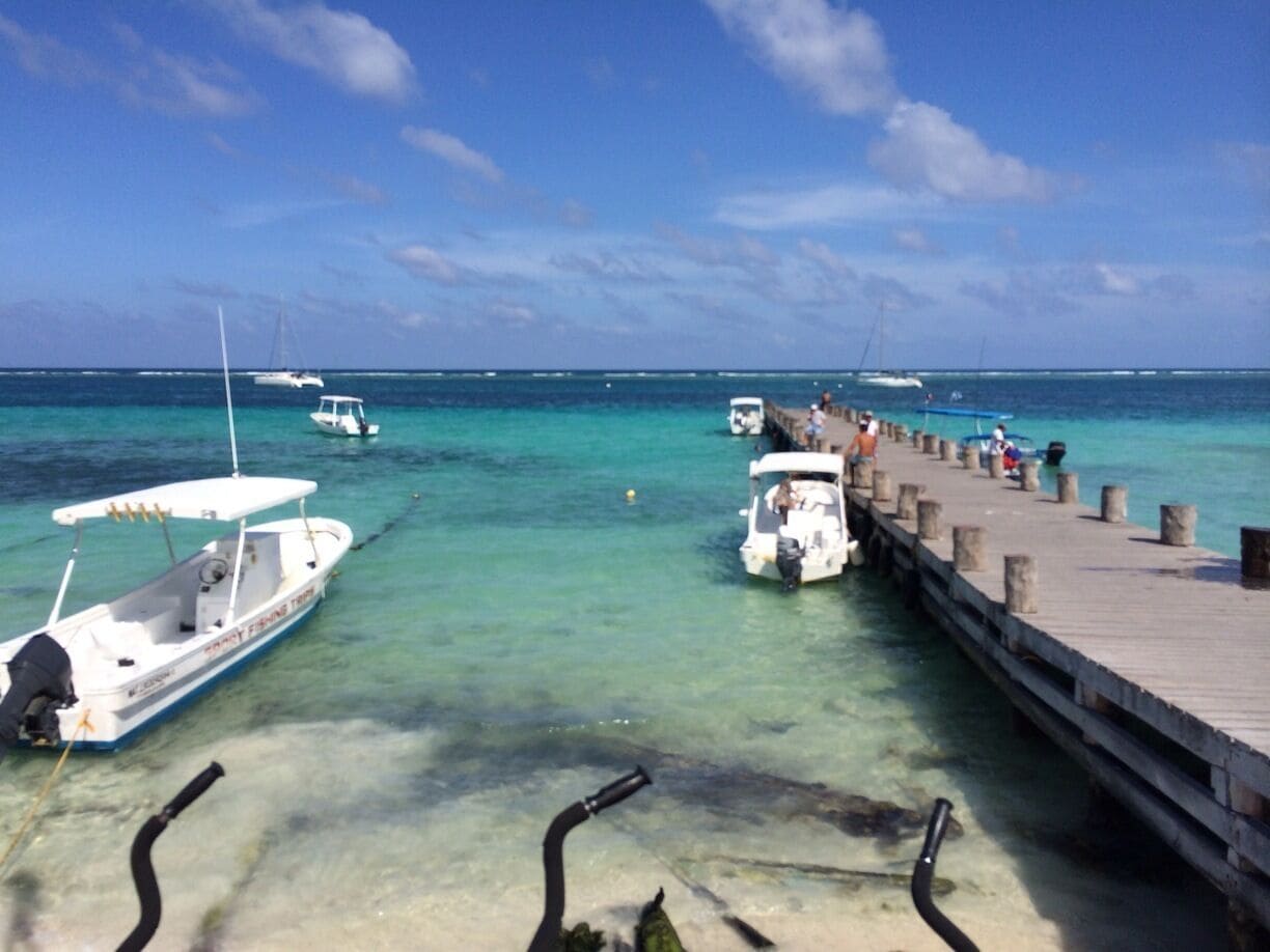 Clear water and out in distance the break of the waves over the large reef.