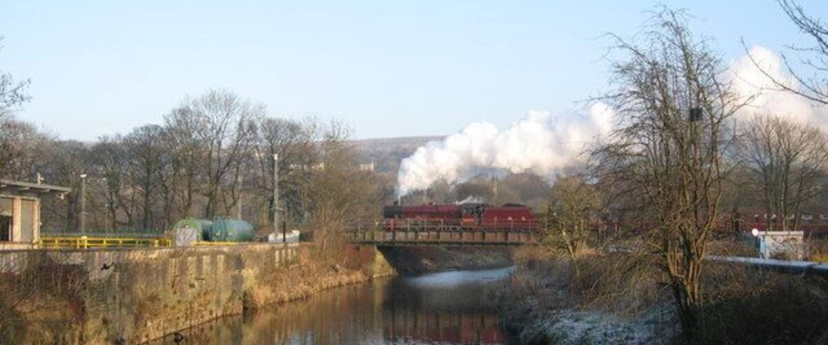 Steam train crossing the river Irwell Jubilee class locomotve No 5690 'Leander' crosses over the river Irwell in Ramsbottom hauling a Santa Special during December. The East Lancashire Railway runs from Heywood to Rawtenstall for more information click on http://east-lancs-rly.co.uk/