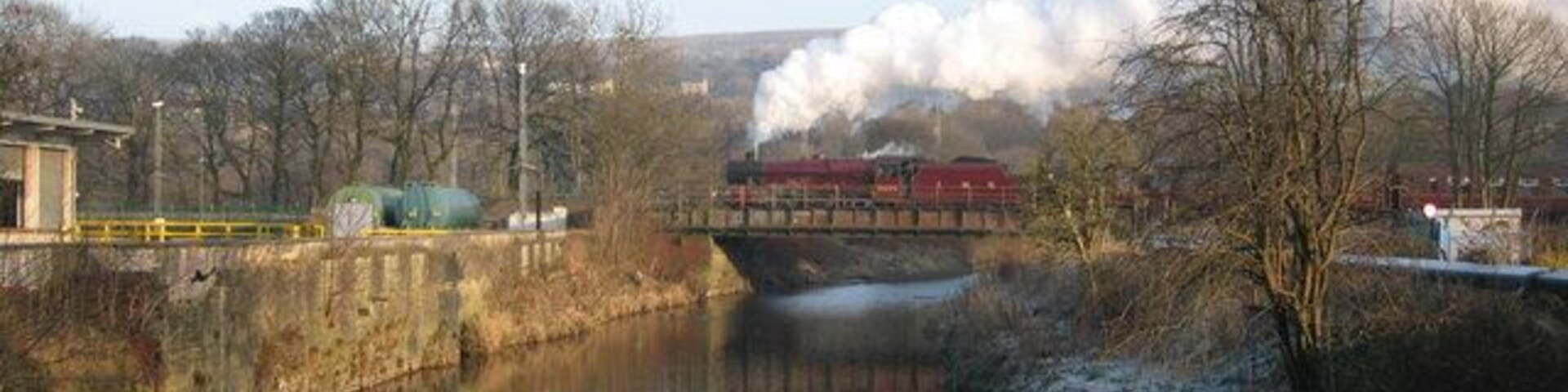 Steam train crossing the river Irwell Jubilee class locomotve No 5690 'Leander' crosses over the river Irwell in Ramsbottom hauling a Santa Special during December. The East Lancashire Railway runs from Heywood to Rawtenstall for more information click on http://east-lancs-rly.co.uk/