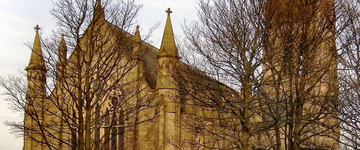 A historic church with a tall spire and multiple pointed towers.