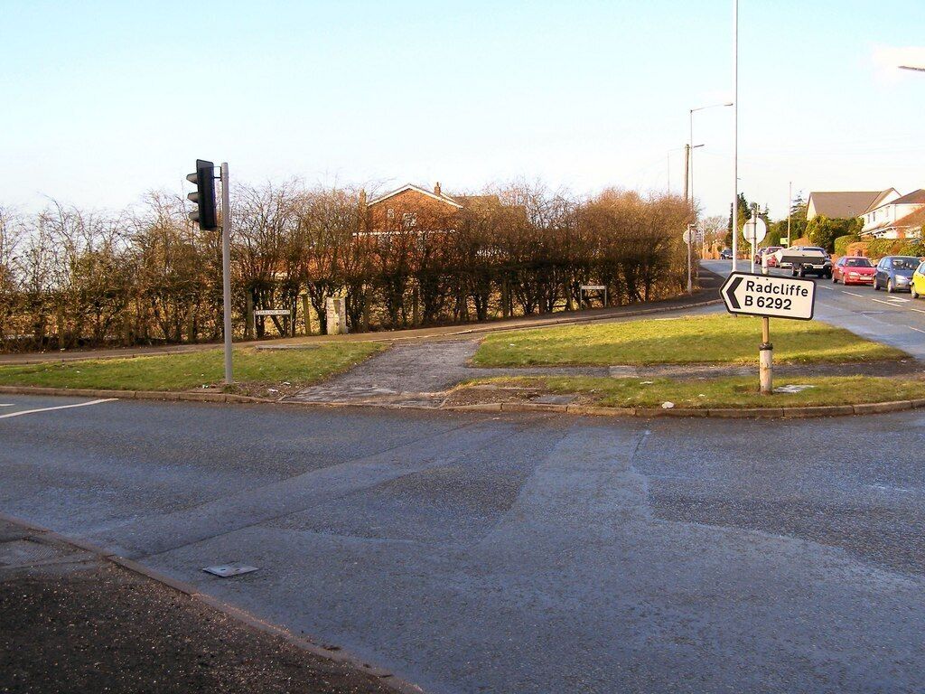 Starling Road. Starling Road at its junction with Cockey moor Road, Lowercroft Road and Ainsworth Road. The old guidepost 1701989 can be seen in front of the hedge.