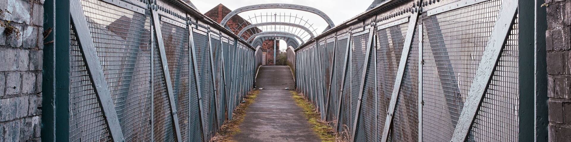 old iron footbridge over railway lines