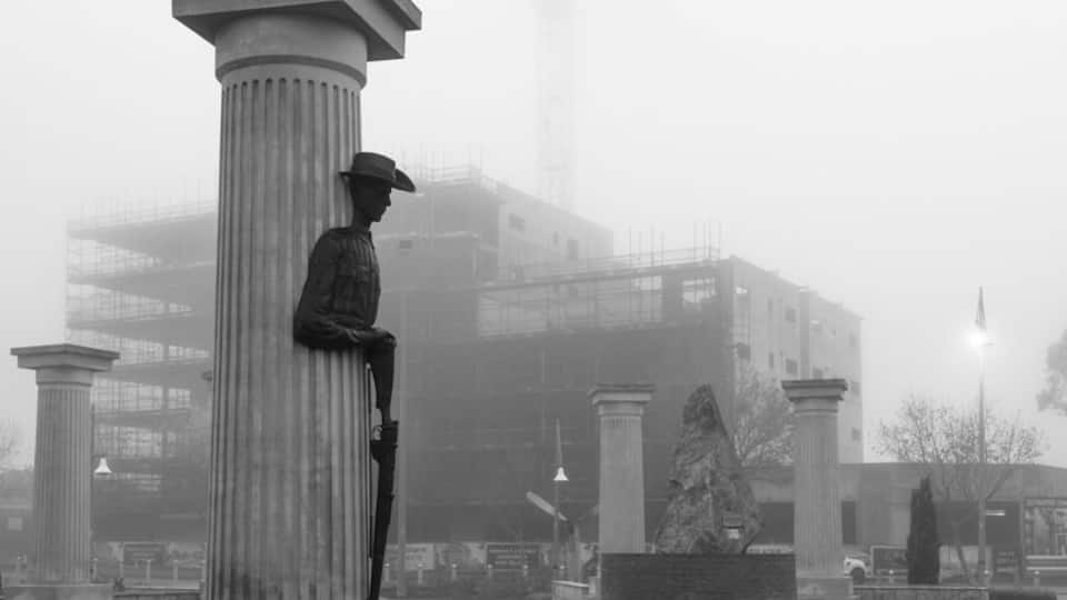 Caught in the fog in early July, the next highrise emerges to overlook the memorial.