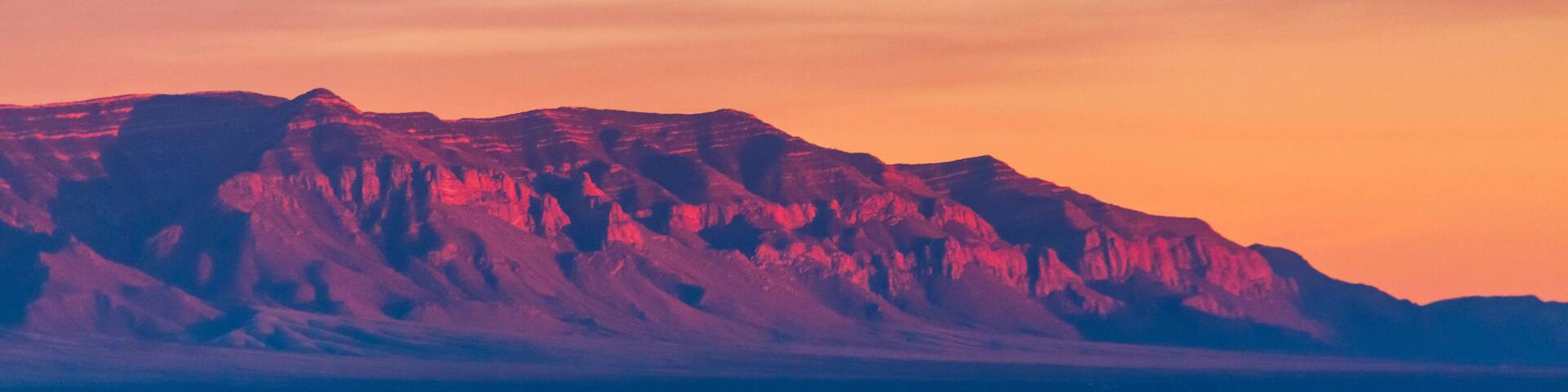 Fiery sunset illuminating the rocky mountains in New Mexico