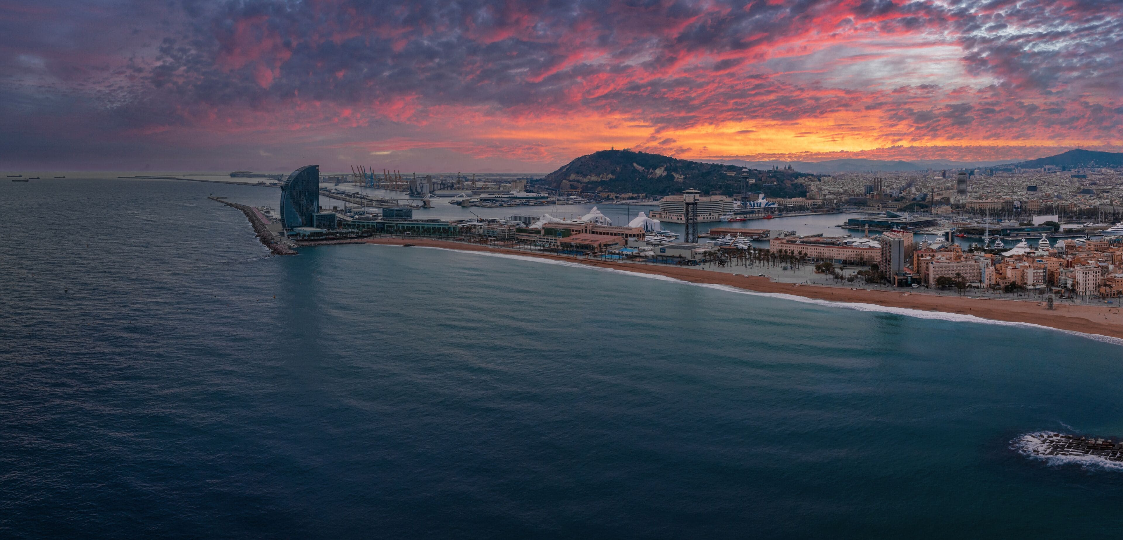 Panoramic aerial view of famous Barceloneta beach with hotel luxury W Barcelona. Birds eye of Barcelona, Catalunya, Spain.