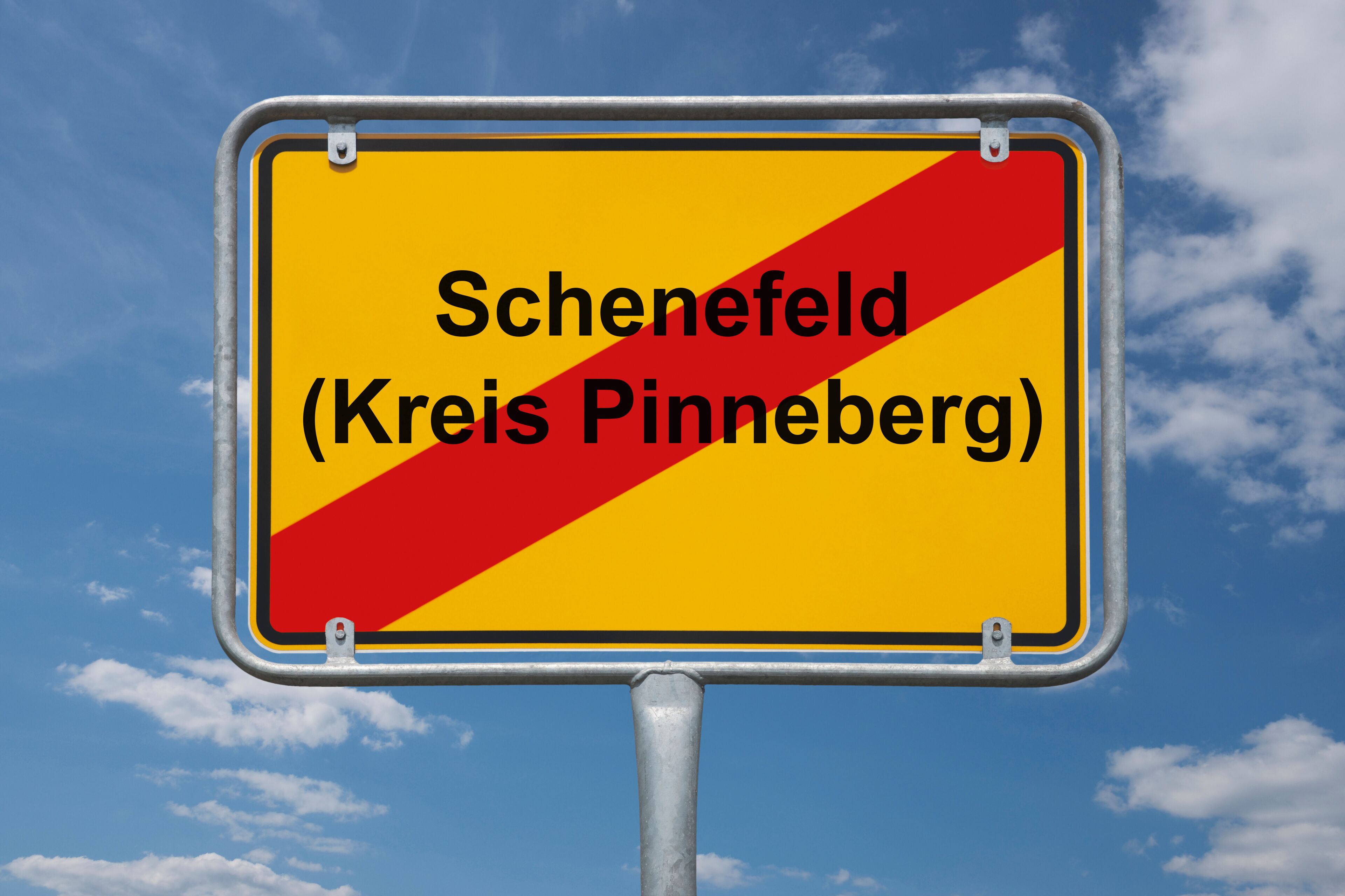A road sign with the text "Schenefeld (Kreis Pinneberg)" against a blue sky with clouds.