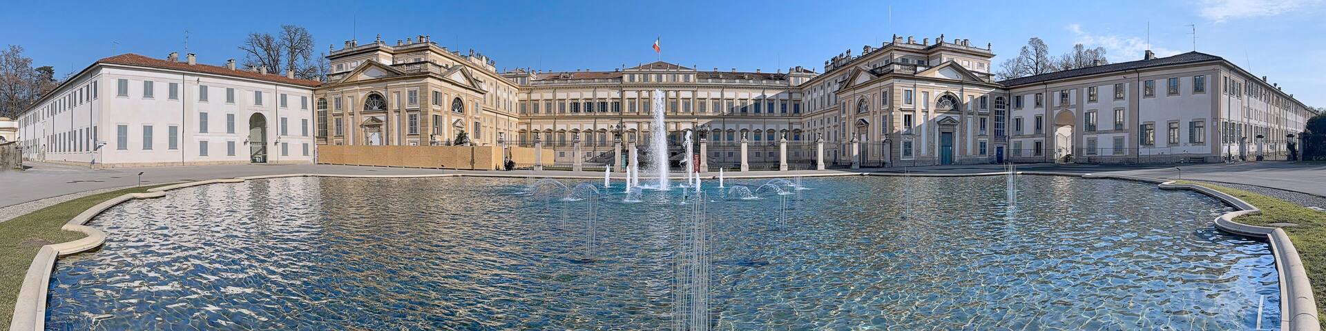 A grand historic building with a central fountain.