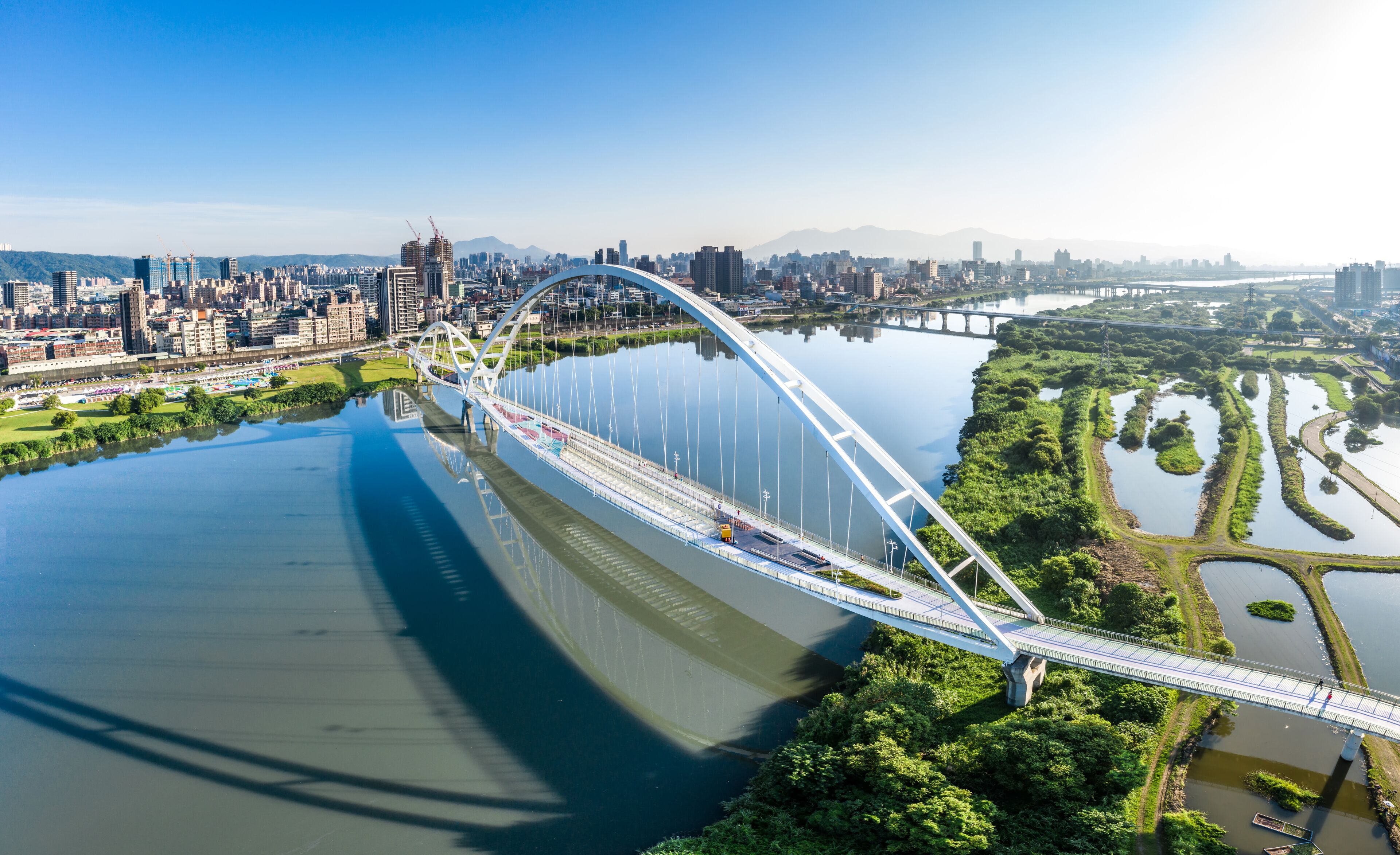 Crescent Bridge - landmark of New Taipei, Taiwan with beautiful illumination at day, aerial photography in New Taipei, Taiwan.