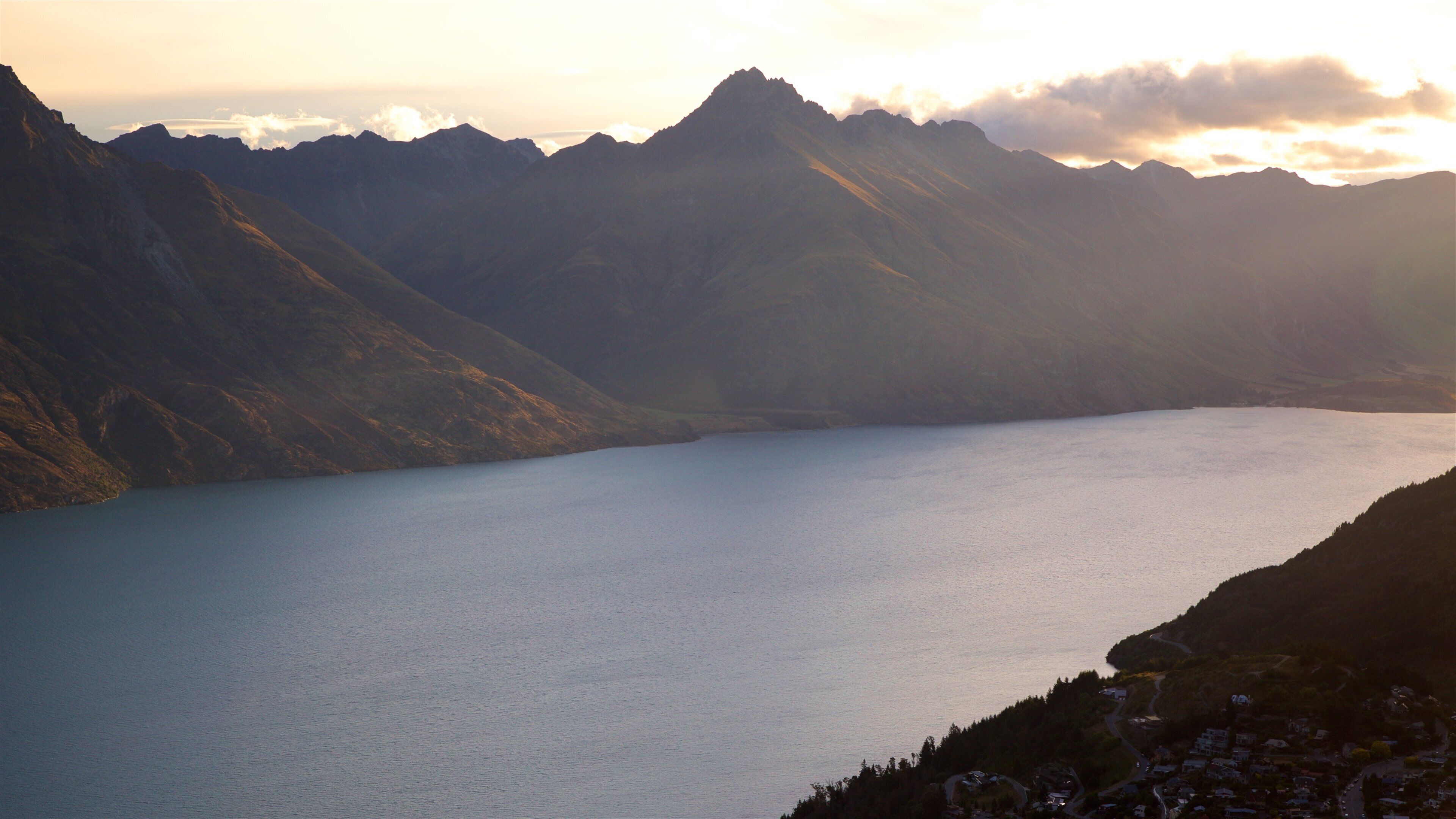 Sunshine Bay featuring a sunset, a lake or waterhole and mountains