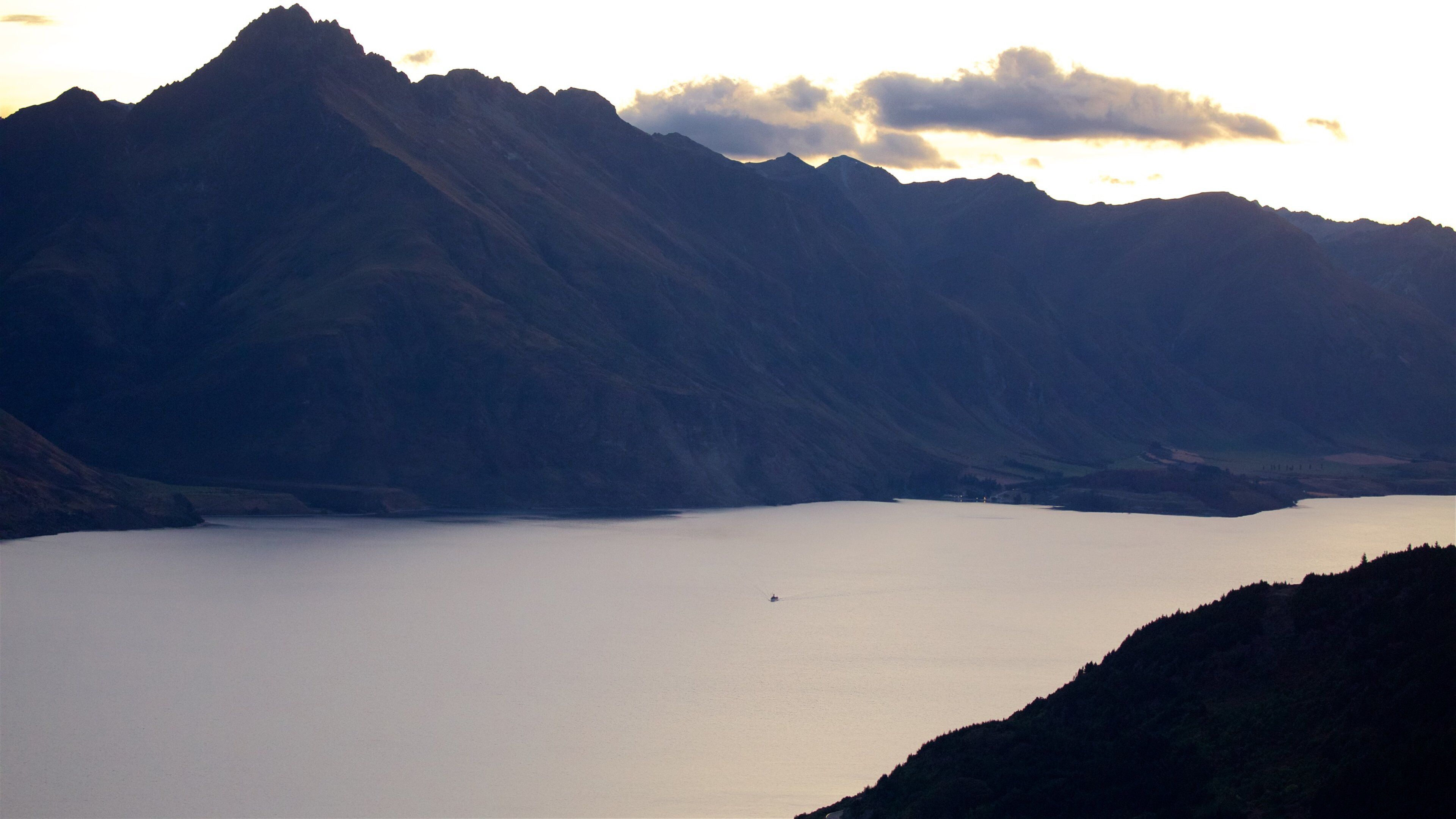Sunshine Bay featuring a sunset, mountains and a lake or waterhole