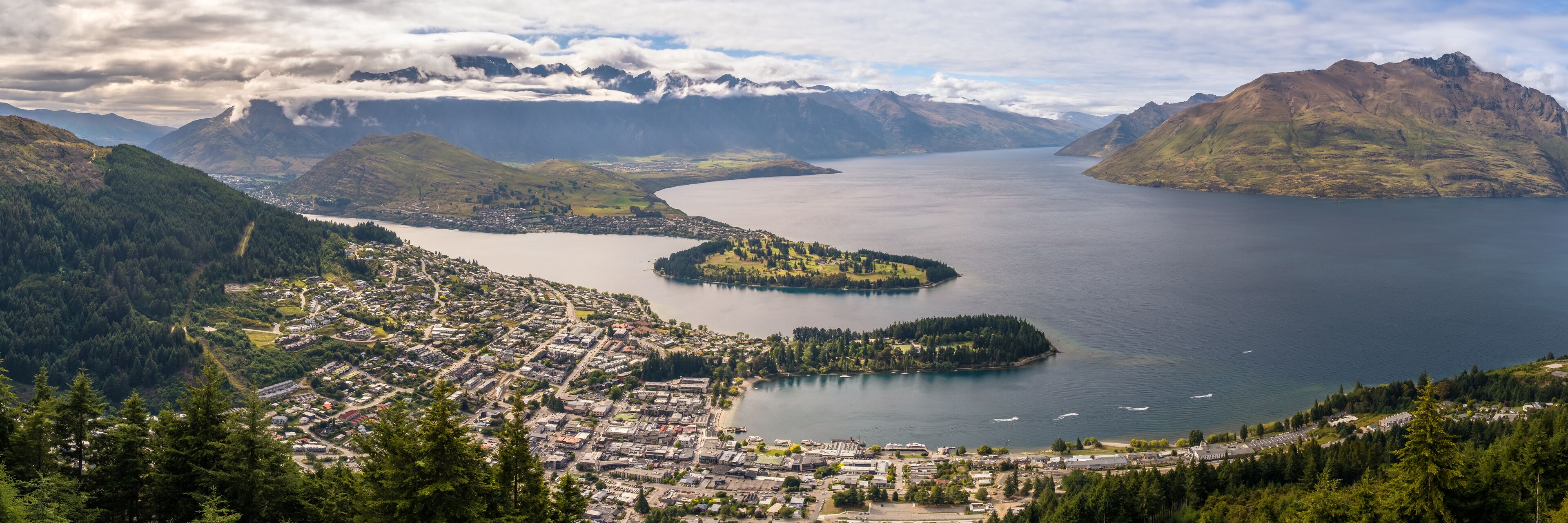 Panoramic view over Queenstown and Lake Wakatipu on the South Island of New Zealand with the Remarkables mountains in the distance