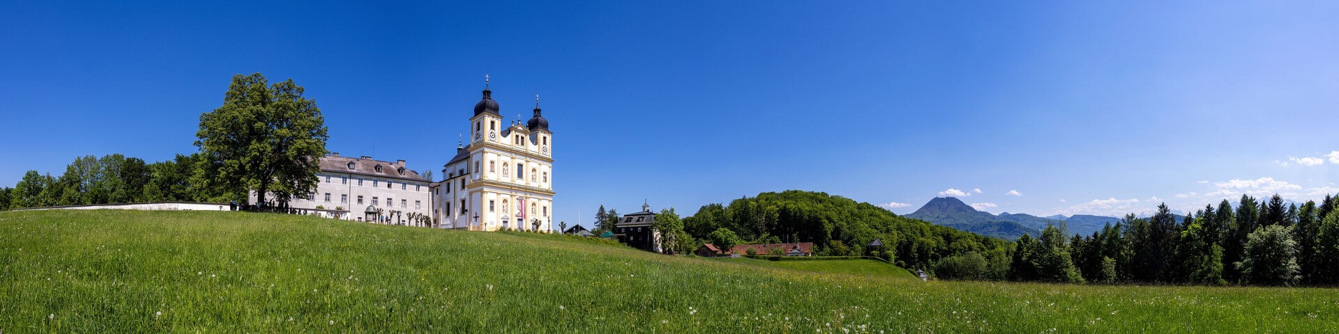 A large castle on a hill with a clear blue sky.