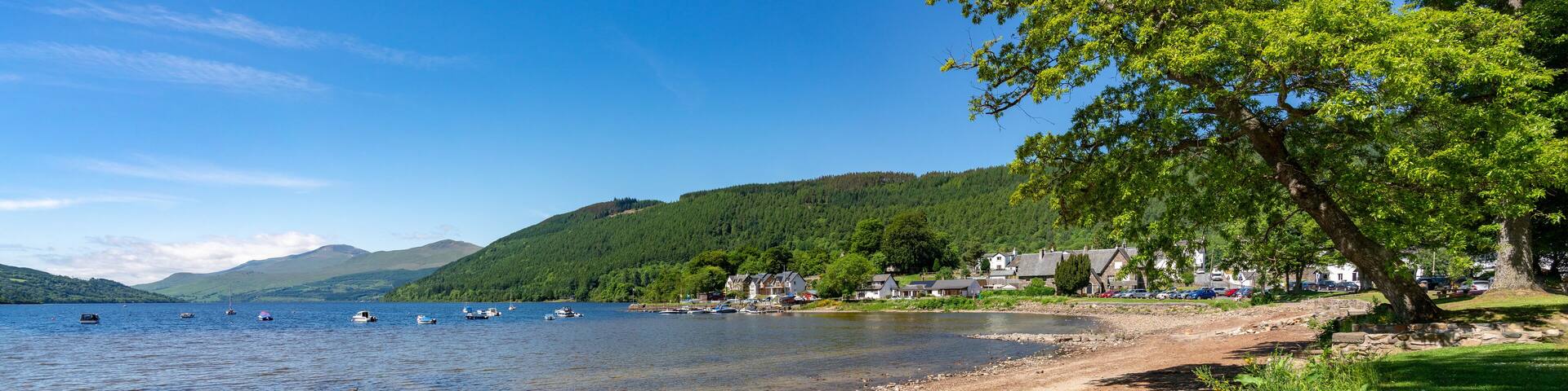 The shore of Loch Rannoch at Kinloch Rannoch near Taymouth on a sunny day in the Scottish Highlands, UK.
