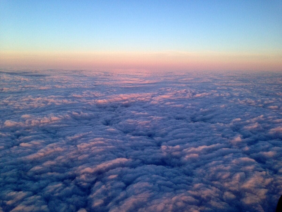 A view of clouds from above, with a clear sky above and below.