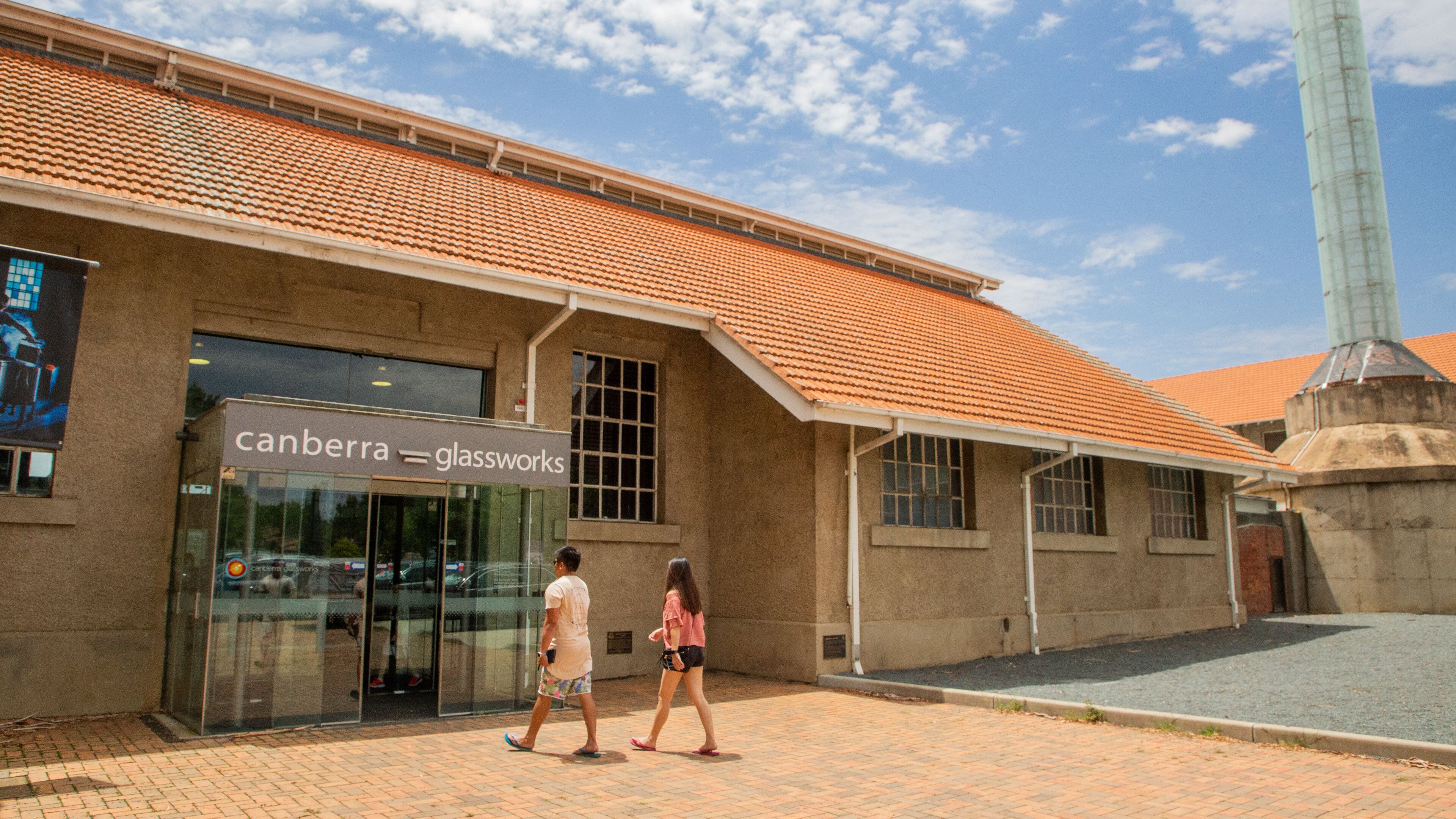 A building with a tiled roof and a glass storefront.