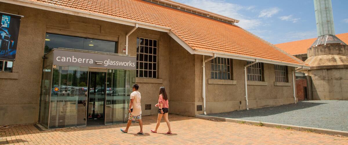 A building with a tiled roof and a glass storefront.